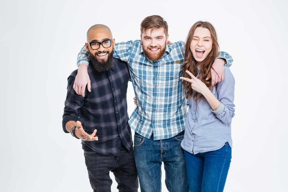Group of happy three friends in casual wear standing and laughing-1